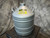 Dewar turned to show a yellow CAUTION liquid nitrogen sticker on the shoulder
