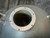 Looking down into the open neck with its bolt-hole ring and orange marker writing