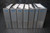 A row of thick, metallic grey binders labeled 'CRAY RESEARCH INC.' containing various technical documents on a textured black surface. The binders are tightly packed and slightly uneven with pages visibly bulging, indicating extensive use and important contents related to Cray supercomputing systems.