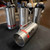 A group of stainless steel foam branchpipes with handles and red tape, labeled "Angus Fire" and "MEX-450," arranged on a black padded surface. This is the Angus Fire MEX-450 model available from Obtainium Science & Industry Surplus.