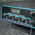 LCD reading "037," four channel knobs set to AUTO, Power/Channel Select knob visible; minor scratches on upper bezel edge.