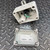 Open view of the Duct Temperature Sensor by Automation Components from Obtainium Science and Surplus, showing internal wiring and the detached cover placed nearby. The sensor components are on a textured metal background.