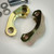 Inside face of a yellow zinc clamp half showing the flange shoulder and bolt holes