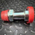 Straight split flange adapter with red caps on both ends and a body hex near one end