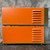 Two stacked Dimetrics Orbital Welding Centaur 75 TIG Welder units, likely models 7001 and 7008, presented from a side angle. Each industrial welding machine features a prominent bright orange chassis with dark olive green end caps. Multiple horizontal ventilation louvers are visible on the right side of each unit, designed for cooling. Silver screws are visible on the front/left edges of the orange panels. The robust, heavyduty welding equipment is suitable for professional orbital TIG welding applications, appearing in good condition for sale.