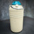 Cream-painted aluminum body with visible scuffs and paint chips across the lower half; metal bail handle and teal plastic cap present.