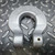 Unused Crosby S-1325A Grade 100 chain coupler, silver U-shaped with USA, CE, GR-100 markings on diamond plate.