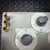 Close-up of the brass terminals and two dials on the General Radio GenRad 1433-F Decade Resistor Box from Obtainium Science and Surplus, showing labeling around the connectors and dial markings.