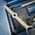 Close-up of a wrench labeled “CLAMPSEAL” resting in a foam-lined tool case beside metal rods and fittings. Conval TK5D-C-S-1 Tool Kit for Size 5D Valves from Obtainium Science and Surplus.