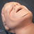 Simulaids Adam manikin head showing clean, flesh-toned surface with no visible damage. Minor dark speck on right cheek.