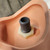 Manikin head connection point showing clean threads on gray tube, hexagonal white plastic nut, and smooth skin-tone plastic.