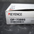 Keyence OP-73865 sensor cable packaging box, displaying the brand logo and the model number "KEYENCE OP-73865" on a white label above a barcode, resting on a dark gray diamond plate surface.