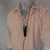Shure Model 560 lavalier microphone worn around the neck on a lanyard, demonstrating hands-free use.