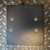 Top panel showing four clean mounting holes and textured black finish with minor surface scuffs.