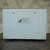 Side cover panel with a HOT SURFACE caution label in English and German