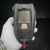 LCD active showing cylinder graphic, psi bar, and dashed alarm indicators. ALARM button intact. Light surface scuffs on housing. Red-capped inlet fitting present.