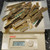 Lot of mixed gold-finger edge connectors weighing on Ohaus LS 200 scale. Varied lengths; oxidation and patina visible on several pieces.