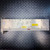 Brushed aluminum top panel with multiple trimmer screws, yellow CAUTION labels, two blue LEDs, red DIP switch array, and J101/J102 connector labels visible.