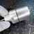 Machined aluminum body with large external male threads, a flat wrench flat, and a circumferential seam with black O-ring visible at the body joint.