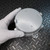 Gray-painted cast aluminum enclosure, top face visible with two small fastener points. Minor surface texture variation on lid. Small partial label readable on side edge.