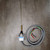 Cast aluminum body with long thin wobble wire and coil spring boot; blue label shows CAT 914CE20-3, MADE IN UNITED KINGDOM; four-conductor gray cable with black, white, red, green leads.