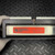 Red label on brushed aluminum housing reads S/N: X07763, firmware 1983, 1986, 1995. White terminal block and edge connectors visible above.