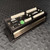 Black anodized panel with wiring panel no. 13349 stamped on face, green 12V power terminal block installed, 9-pin serial D-sub female port present, terminals unmarked by wear.