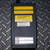 Back side of the Ron 2000 Crane Dynamometer display unit from Obtainium Science and Surplus, with warning labels, calibration stickers, and maximum load rating visible.
