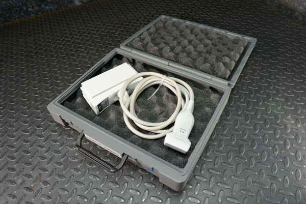 Siemens Acuson 6L3 ultrasound transducer probe in an open gray hard case with foam, alongside white accessories.