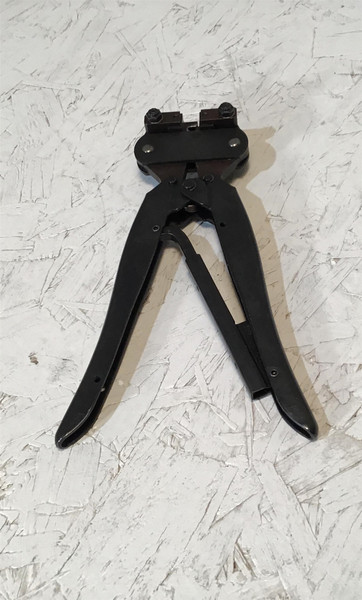 Black AMP Crimp Tool - Optimate 58190-5 Crimper displayed on a textured white surface, with its handles partially open and the tool in full view.