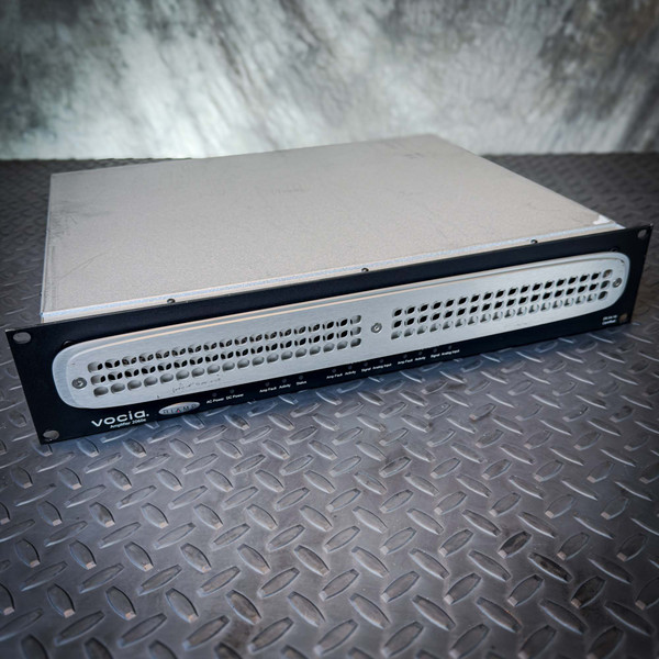 Angled front view of a Biamp Vocia VA-2060e 2-Channel CobraNet Network Amplifier from Obtainium Science and Surplus, showing the vented front panel and rack-mount frame.