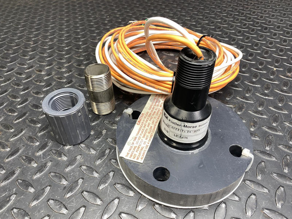 Kistler-Morse transducer on its flange beside a coiled cable, coupling and pipe nipple