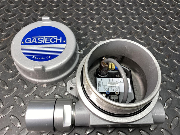 Open Killark HKB Hazardous Enclosure with Gastech Transmitter from Obtainium Science and Surplus, showing internal wiring components, placed on a metal diamond plate surface.