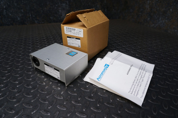 Acromag 3941 C-Type Thermocouple Reference from Obtainium Science and Surplus shown with its original cardboard packaging and accompanying product documentation, all displayed on a textured black metal surface.