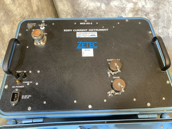 Zetec MIZ-30-2 Eddy Current Instrument showing front panel with connectors, AC power inlet, and fuse holders. Label "MIZ-30-2" visible. Connectors for AUX/NAV, LAN, and PROBE are present, with one large multi-pin connector exposed. Two "BOARD A & B" ports covered with caps. Panel shows scuffs and minor scratches.