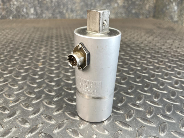 A Norbar Torque Transducer with a 500 LBF·FT capacity and 3/4" drive, captured standing upright on a textured metal surface. The unit is silver with a visible connector port. This item is listed from Obtainium Science and Surplus.