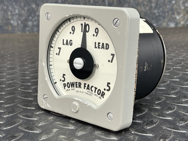 Panel-mount power factor meter, LAG/LEAD scale 0.5–1.0–0.5, needle resting near unity. Gray housing shows scuffs; rear enclosure has chipped black finish. Model ES-5-D-3WADC visible.