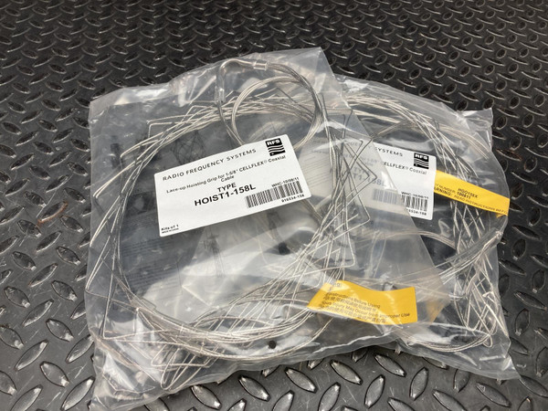 Two factory-sealed poly bags, labels visible reading "TYPE HOIST1-158L" and "CELLFLEX Coaxial." Packaging intact, no tears.