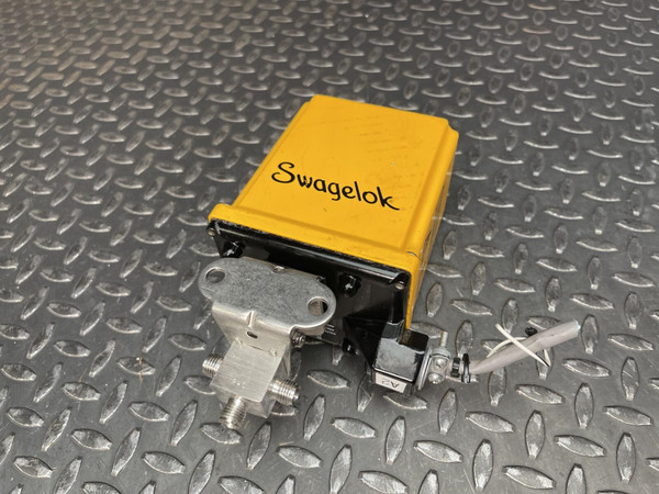 Swagelok MS-142DCx actuator with yellow casing and attached SS-43GXS4 valve assembly.