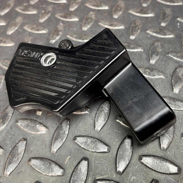 Black plastic body with ribbed rocker surface, MSA logo and circular indicator window visible, minor surface scuffs present.