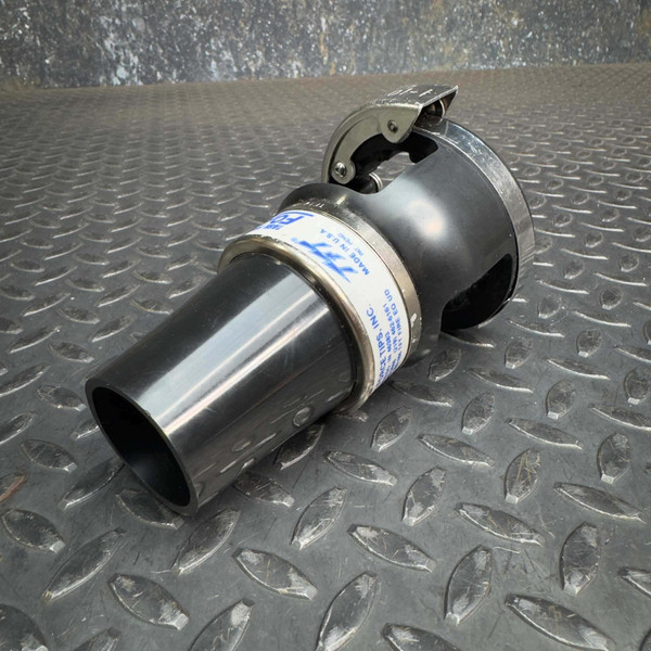 Task Force Tips TFT LX FoamJet firefighter foam-making attachment from Obtainium Science & Industry Surplus, placed on a textured metal surface, showcasing its nozzle and grip handle.