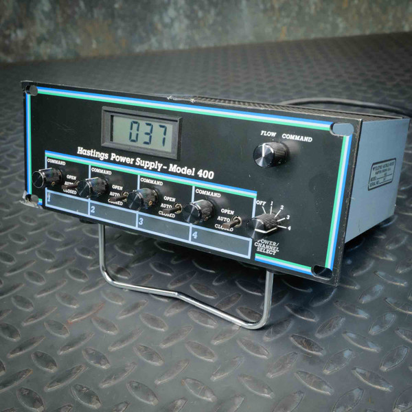 LCD display reads "037." Four channel command knobs present, all intact. Side label partially legible; serial number field visible but unreadable at this angle.