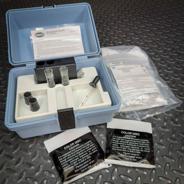 Hach Nitrate-Nitrite Test Kit components showing new condition. Includes instructions, vials, dropper, and two sealed Color Disc packets.