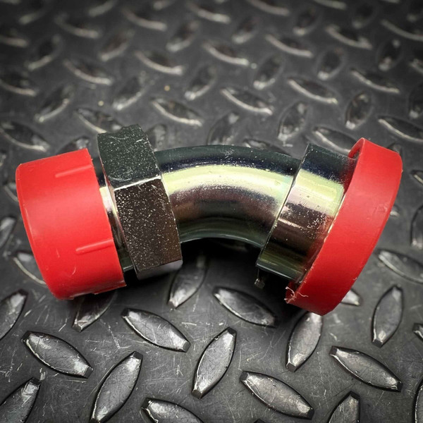 Bright metal 45 degree split flange elbow adapter with red caps on both ends