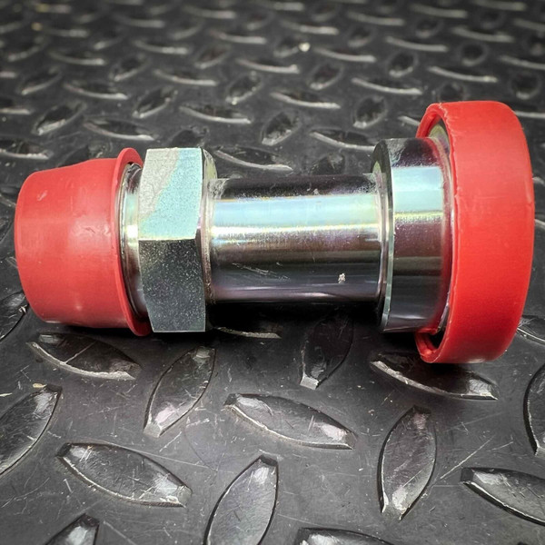 Straight split flange adapter with red caps on both ends and a body hex near one end