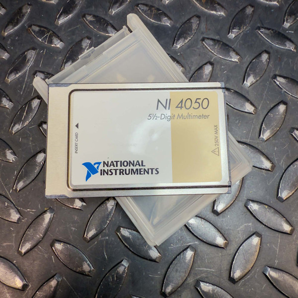 Close-up of the front side of a National Instruments NI 4050 5 1/2-Digit Multimeter PCMCIA Card from Obtainium Science and Surplus. The card has a beige and silver design with the "National Instruments" logo in blue and black, along with the model number "NI 4050" and "5 1/2-Digit Multimeter" printed on it. The background features a black diamond-plate metal surface.