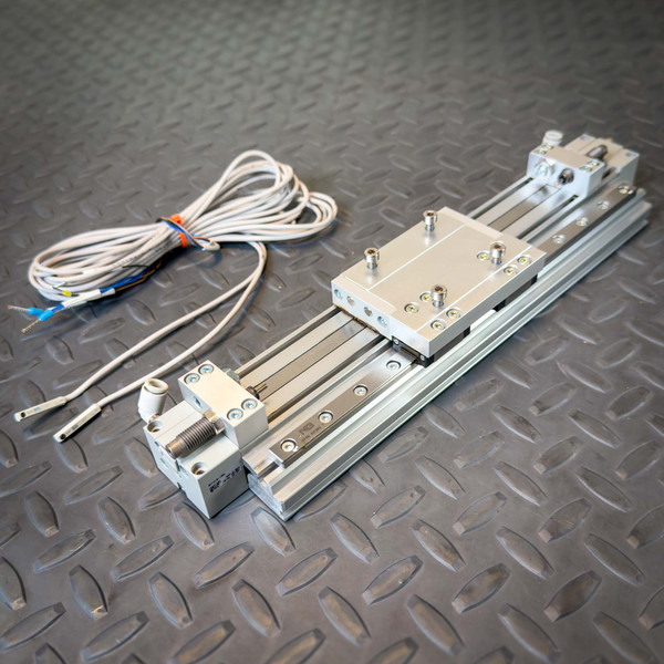 SMC MY1H16-150L Rodless Actuator 150mm from Obtainium Science and Surplus shown on a diamond plate floor with included D-M9P Auto-Switches