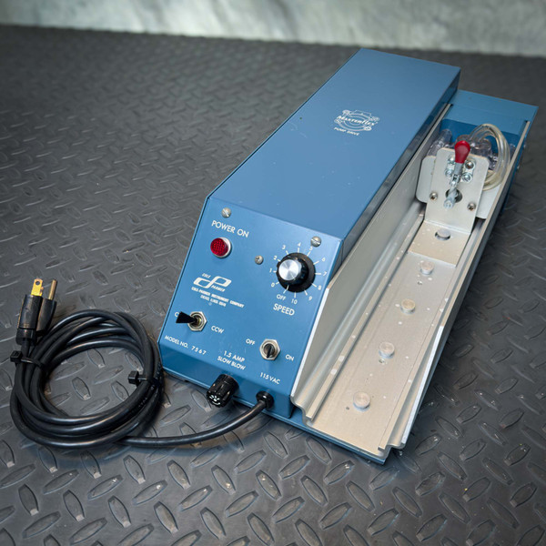 Angled front view of a Cole-Parmer 7567 Multi-Head Pump Drive with 7016 Head from Obtainium Science and Surplus, showing the blue metal casing, speed control knob, power switch, and attached power cord.