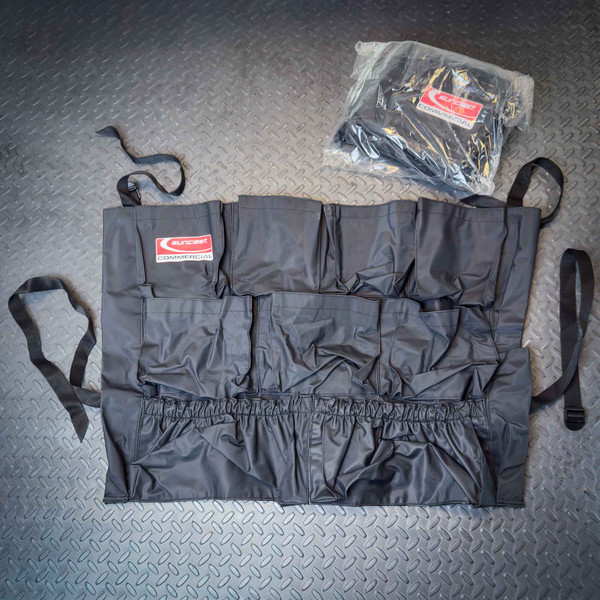 2-Pack, Suncast Commercial Utility Trash Can Caddy Belts shown on a textured gray surface, with one caddy belt unrolled to display multiple pockets and straps, and the second one packaged in clear plastic.