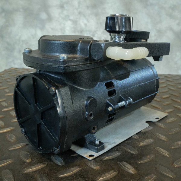 Thomas diaphragm pump showing general wear, one bolt missing from pump head, one bolt missing from motor cover.
